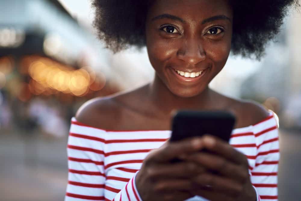 A cute black girl with dry natural hair used cleansing conditioners to co-wash natural hair on wash day.