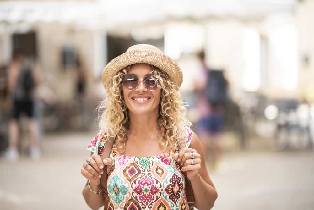 A cheerful middle-aged female used a permanent liquid toner to neutralize warm tones.