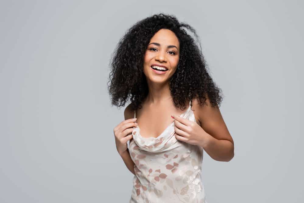 Carrier Oils: What Is a Carrier Oil? Best Oils & How to Use Them 1 A cute black girl wearing a wash-n-go styled with vegetable oils and essential oil blends.