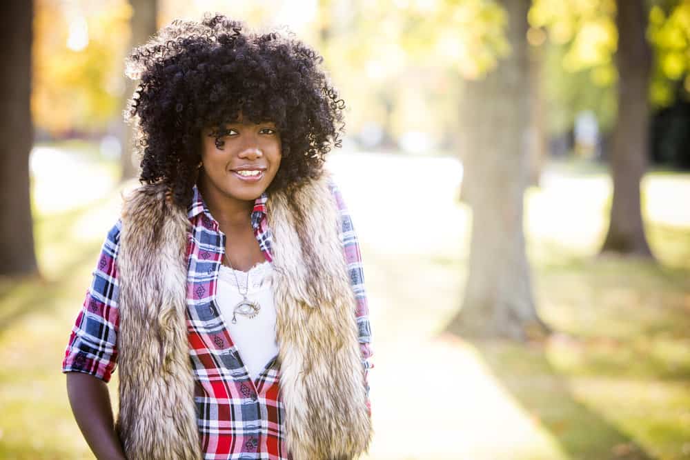 A black lady wearing a curly wig made from horse hair is similar to early wigs from the  Victorian and Edwardian eras.