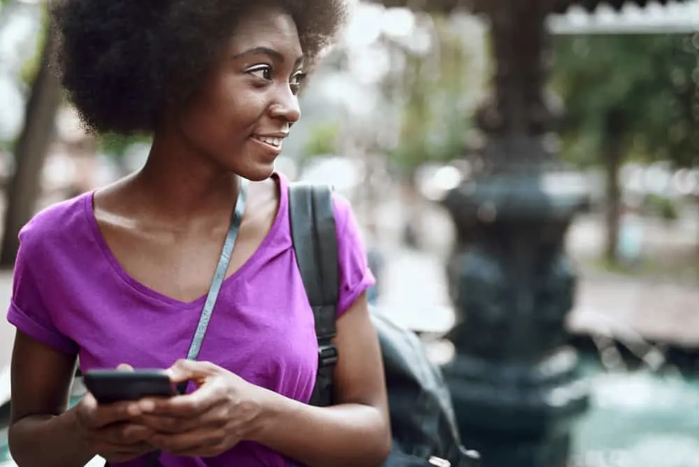 Why Does 4C Hair Shrink? How to Prevent Shrinkage on 4C Hair 3 A pretty African American female with coily hair wearing her curls in a stretched-out look.
