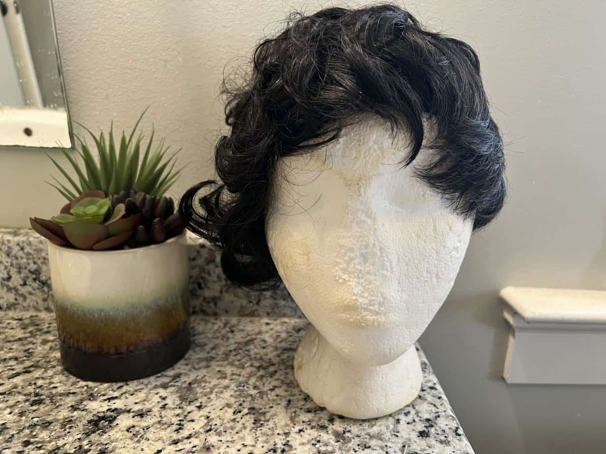 A1 Pacific female Styrofoam mannequin head holding a Hotkis human hair pixie cut wig.