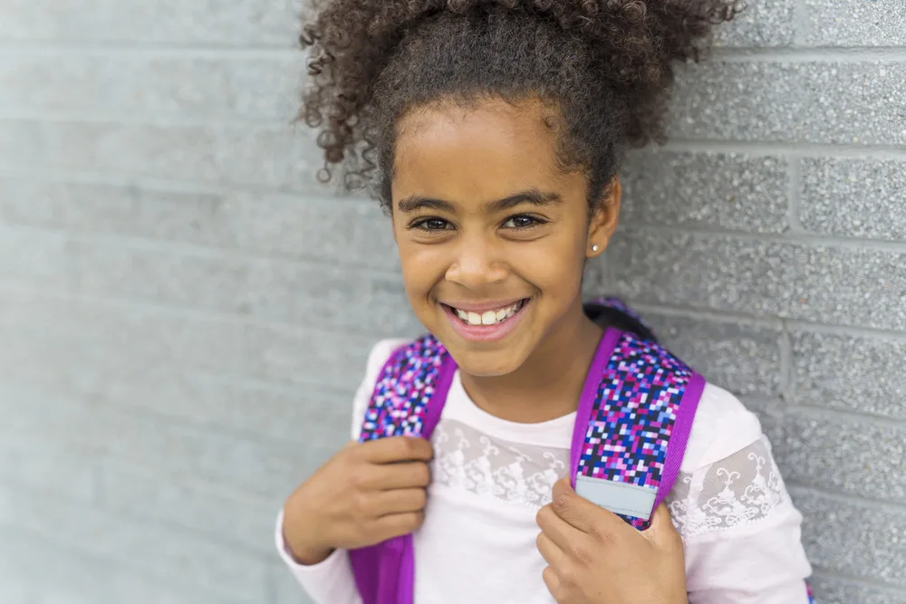 16 Easy 7 Year Old Black Girl Hairstyles: DIY for Little Girls 22 The cute little black girl's simple bun with curly ends is a low-maintenance hairstyle that allows her to express her unique style and personality.