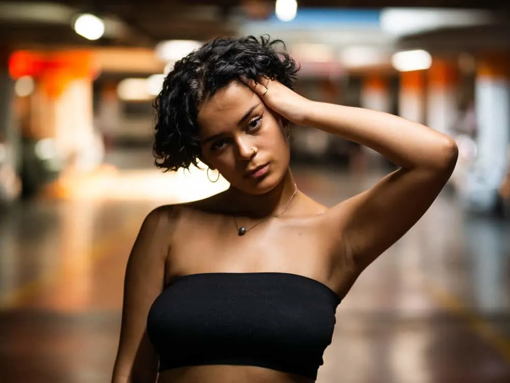 The Bisexual Haircut: How to Create Bi Haircuts & Hairstyles 1 A cute young female wearing a bi bob hairstyle on wavy hair. This bisexual bob haircut is often worn by bi women in the queer community.