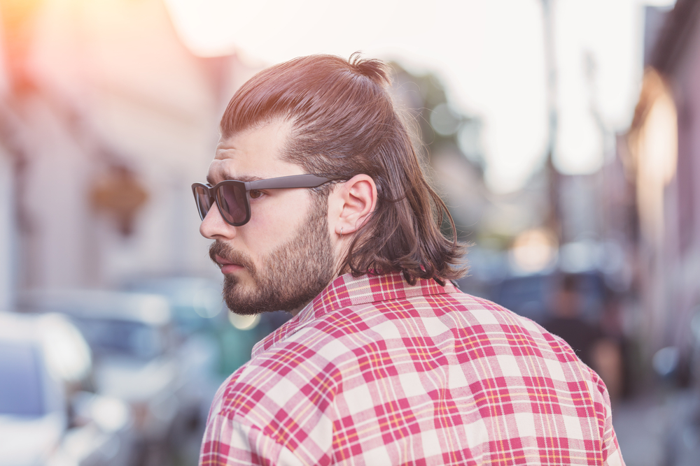 The addition of baby bangs adds an interesting element to his Mexican mullet, creating a striking contrast against the flowing locks.