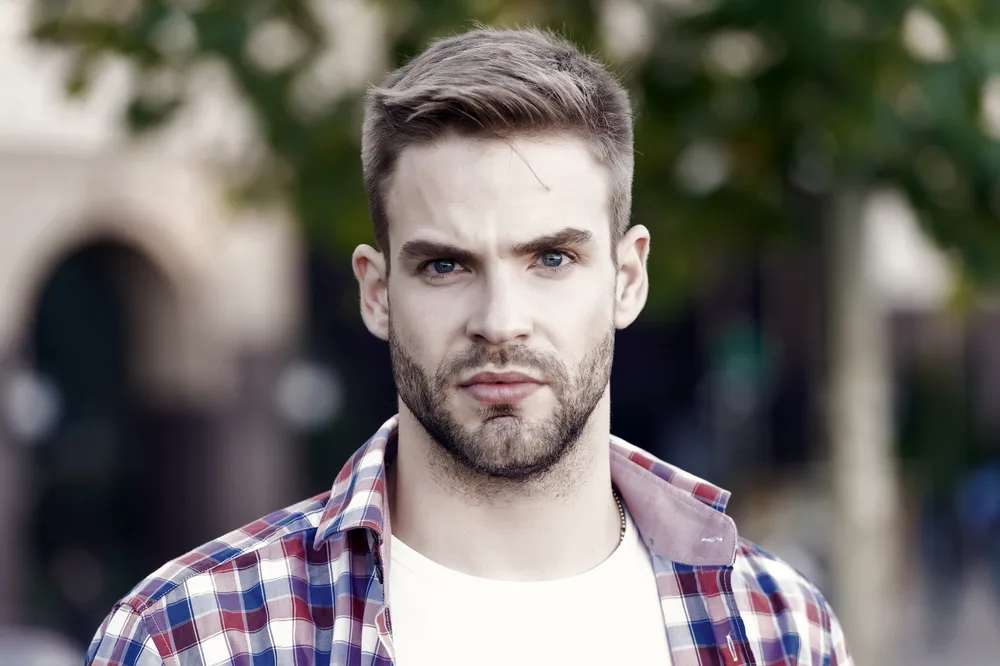 Hairstyles for Men with Big Foreheads: Step-by-Step Tutorials 29 The Caesar cut, with its short and textured fringe, adds a touch of sophistication to his hairstyle, highlighting his refined taste.