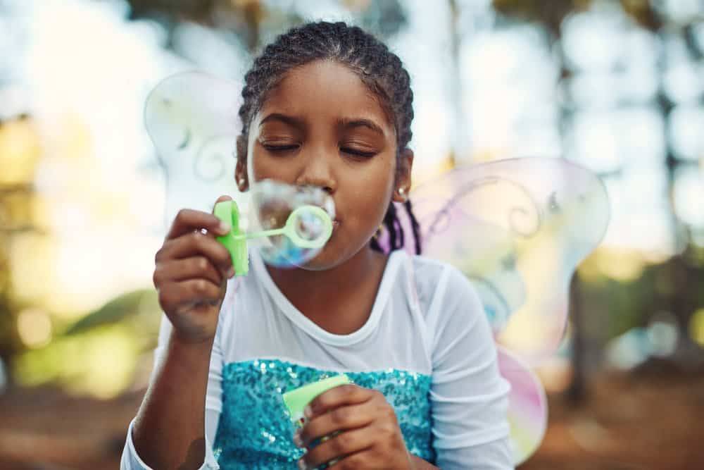 With ombre box braids that cascade down her back, the little girl exudes confidence and style beyond her years.