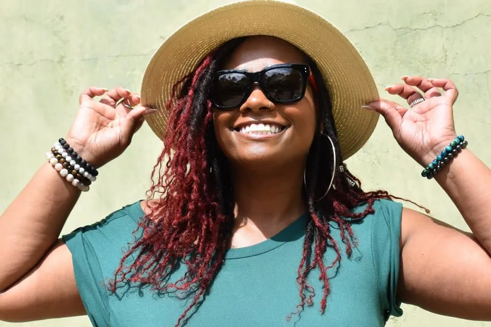 Butterfly Locs: How to Do Butterfly Loc Hairstyles at Home 31 The curly loops created by her butterfly locs with filler hair add a touch of playfulness and uniqueness to her hairstyle.