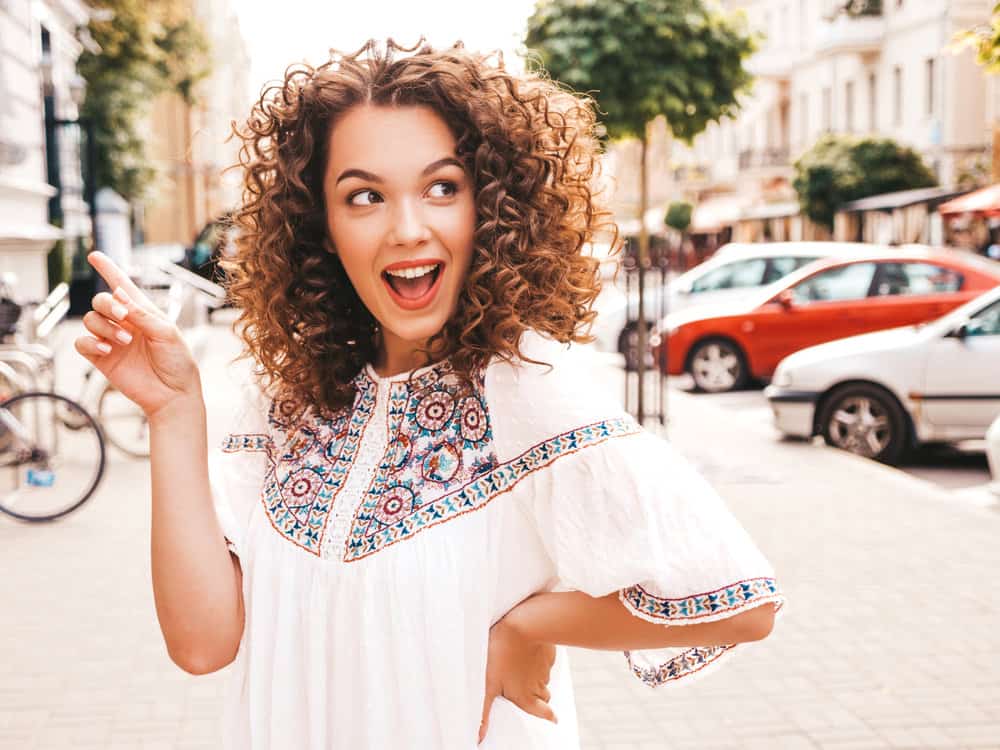 The mesmerizing waves adorning the white beauty's hair are the result of a Korean digital perm, offering soft curls that perfectly frame her face.