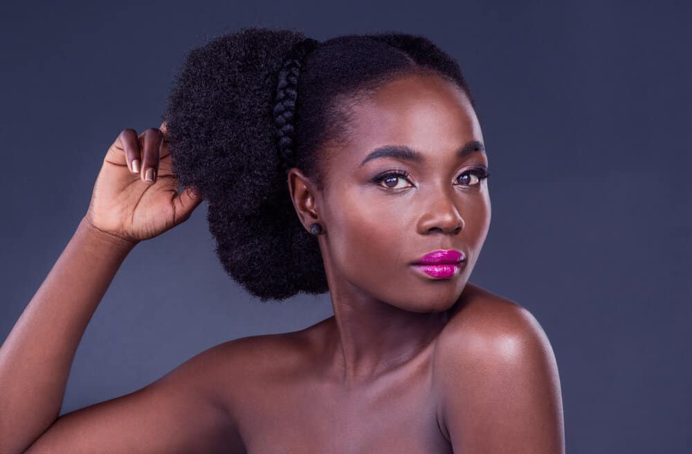 The beautiful black girl's hair responds well to natural oils like avocado oil and mineral oil, as they are the only true moisturizers that can penetrate the hair shaft and maintain moisture.