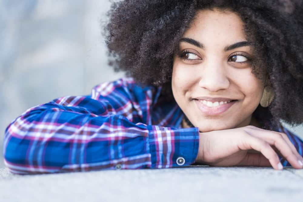 As she brushes her wet hair, she ensures that she follows the correct technique, starting from the ends and working her way up to prevent breakage and keep her curls healthy.