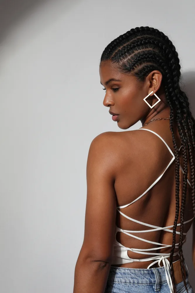 The gorgeous African American lady rocks stunning cornrows or boxer braids, showcasing her unique twist on a traditional and culturally significant hairstyle.