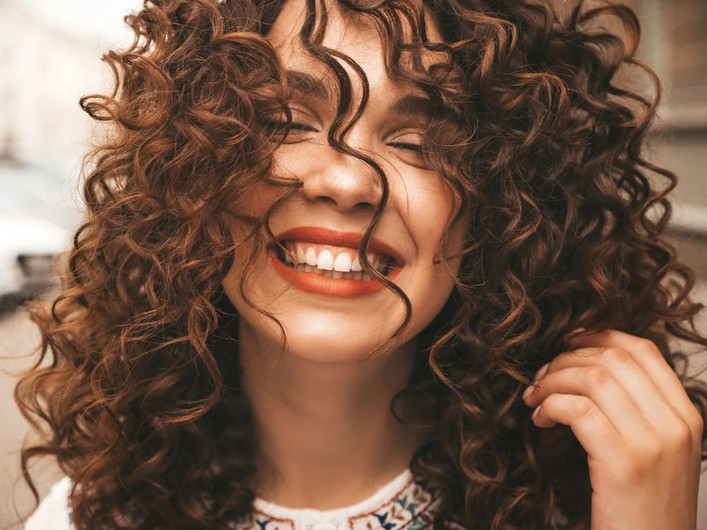 Digital Perm: What Are Digital Perms and How Do They Work? 1 A beautiful white girl with healthy hair has digitally permed hair instead of a traditional perm to create natural-looking waves.