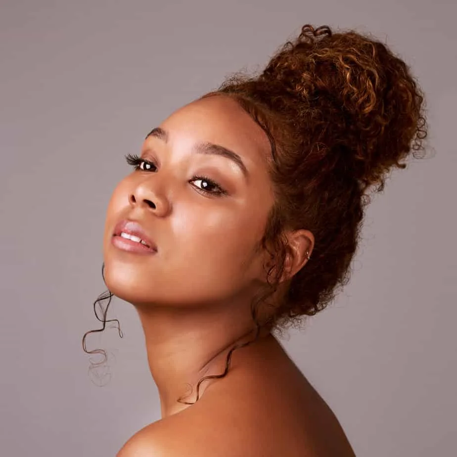 9 Easy Curly Hair Updos: How to Create Curly Updo Hairstyles 20 A beautiful woman with medium hair length wearing one of the most popular updos for curly hair with dried curls.