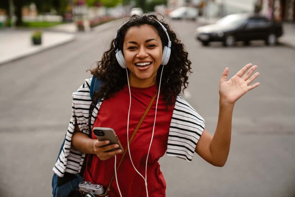 She achieves a frizz-free style by sleeping on a silk pillowcase or wrapping her hair in a silk scarf, minimizing bed head, and preserving her tighter curls.