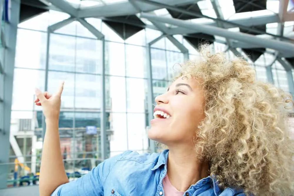 How to Bleach Hair: DIY Bleaching Hair at Home Safely 6 The professional colorist carefully applies bleach powder to her dark hair, ensuring a safe and controlled lightening process.