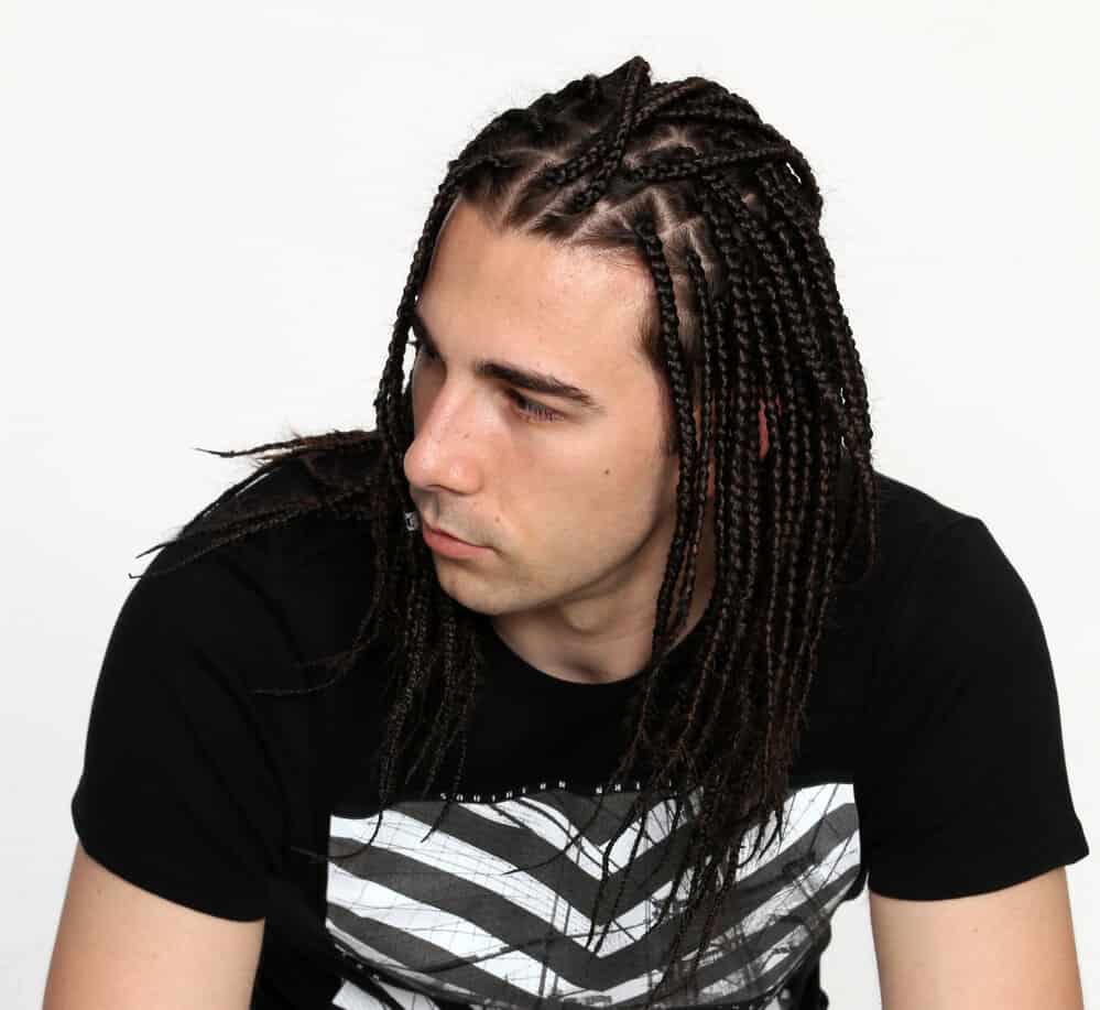 With his thin hair woven into stylish braids, the white guy effortlessly embraces the versatility of braided hairstyles traditionally seen on black men.