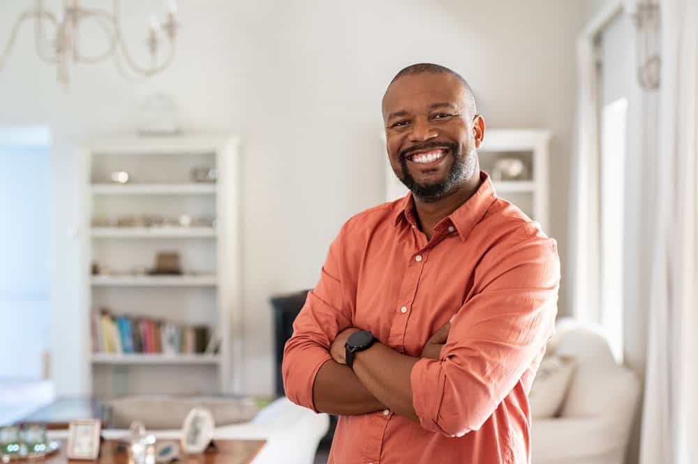 An after photo of an African American male with Bosley's follicular unit grafts, new strands of hair are transplanted to the recipient areas, filling in bald spots.