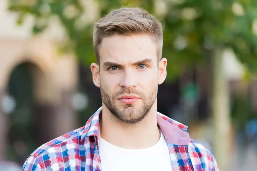 Hairstyles for Men with Big Foreheads: Step-by-Step Tutorials 7 His wavy hair cascades effortlessly, creating a soft and romantic aesthetic that complements his oval face shape.