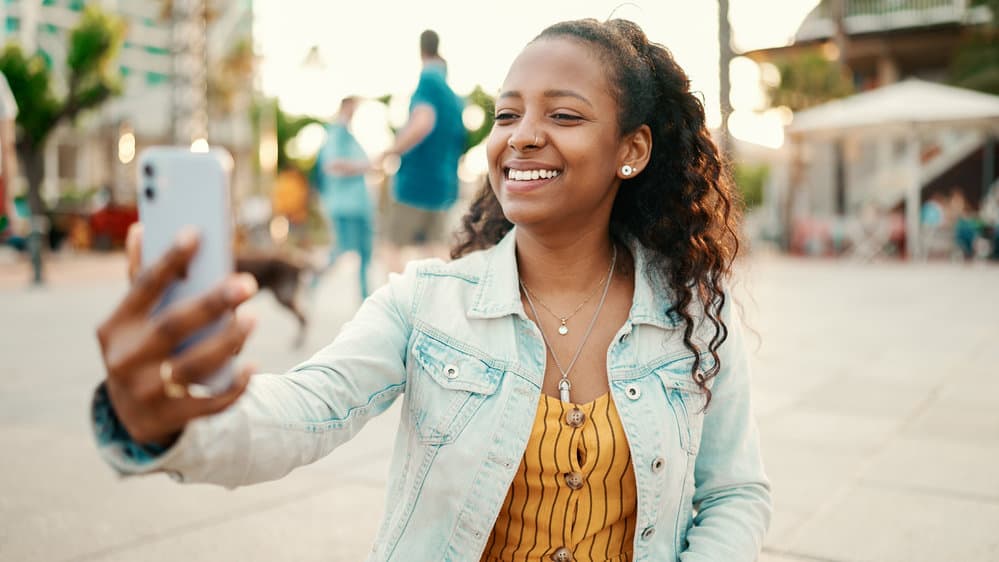 The young lady understands the importance of keeping her hair hydrated, a key principle of the Curly Girl Method for maintaining smooth curls.