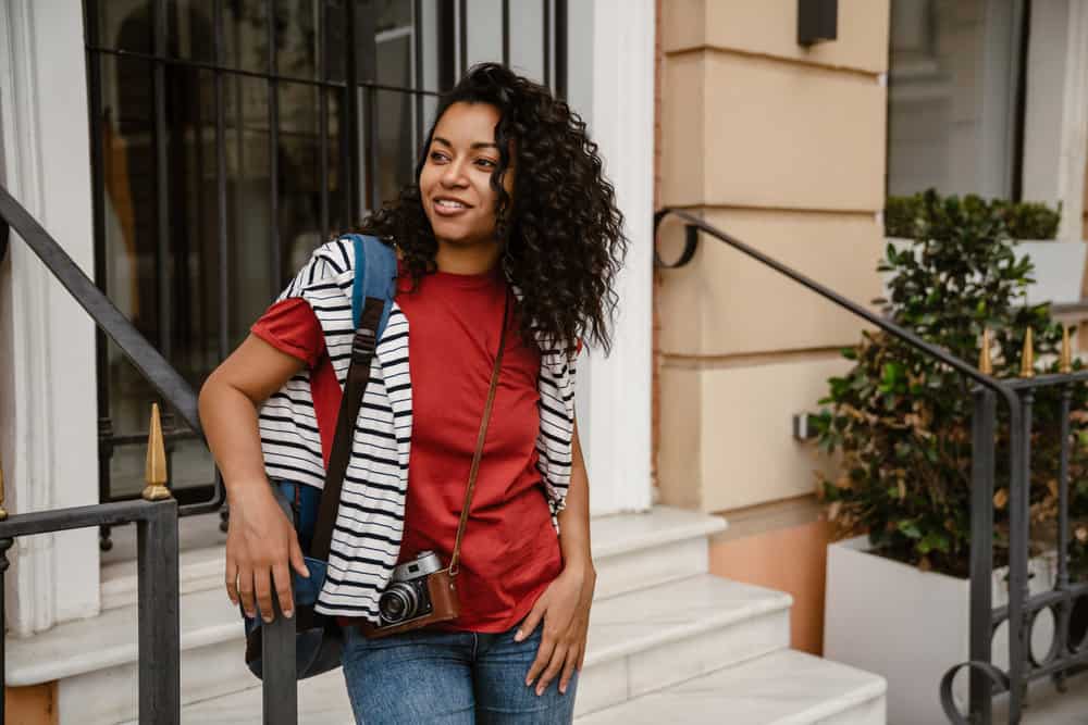 In her night time routine, she gently pulls her hair into a loose ponytail or mini braids, securing them with a satin scrunchie, hair bonnet, or hair tie.