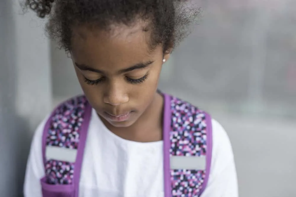 16 Easy 7 Year Old Black Girl Hairstyles: DIY for Little Girls 16 The young black girls simple bun with curly ends is a timeless and stylish choice, highlighting her long hair and showcasing her beauty with creative hairstyles.