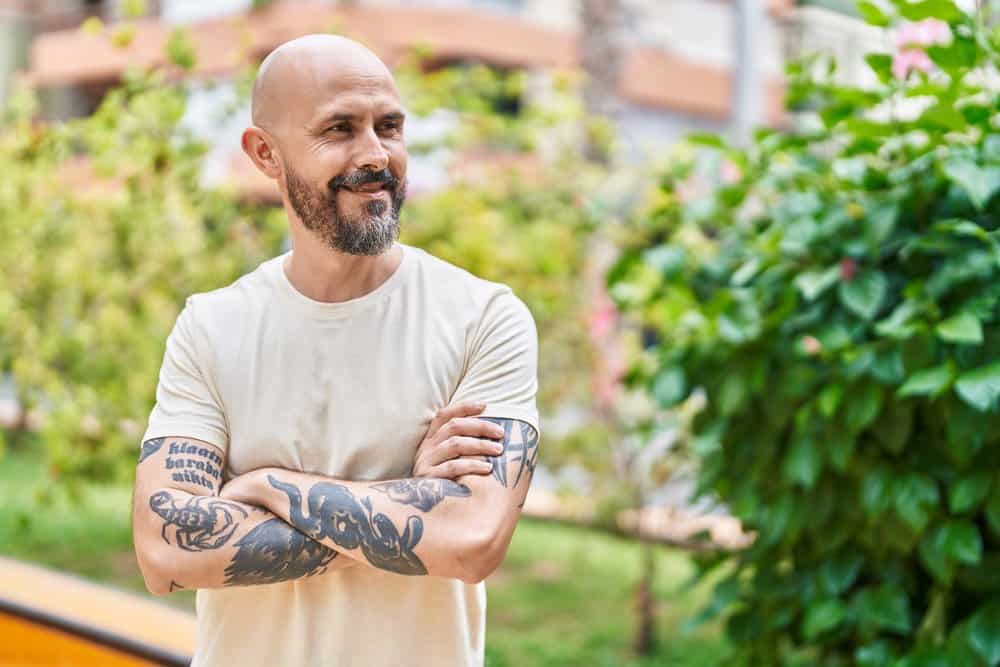 With his short hair and bald head, the young man showcases a bold and timeless look that exudes confidence.