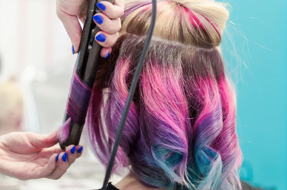 8 Underdye Hair Coloring Trends, Ideas, and Hairstyle Tips 10 The peekaboo warm blonde highlights underneath his dark tresses create a captivating and dynamic effect, adding depth to his hairstyle.