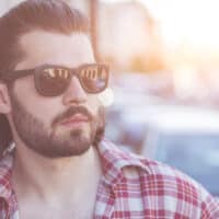 The guy confidently rocks his thick, straight hair in a short Mexican mullet haircut, exuding an edgy and fashionable vibe.