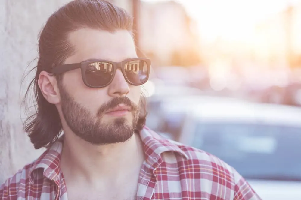 Mexican Mullet Hairstyles: Popular Mullet Haircuts & Styles 3 The guy confidently rocks his thick, straight hair in a short Mexican mullet haircut, exuding an edgy and fashionable vibe.