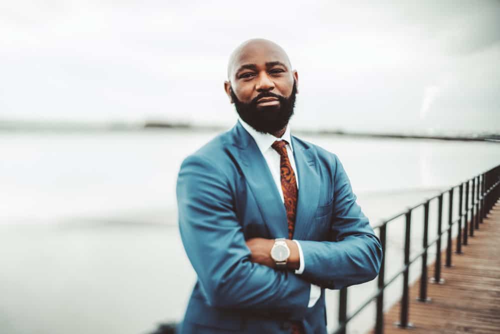 Though his hair may be thinning, the gentleman maintains an air of confidence with his mid-skin fade and natural hair length.