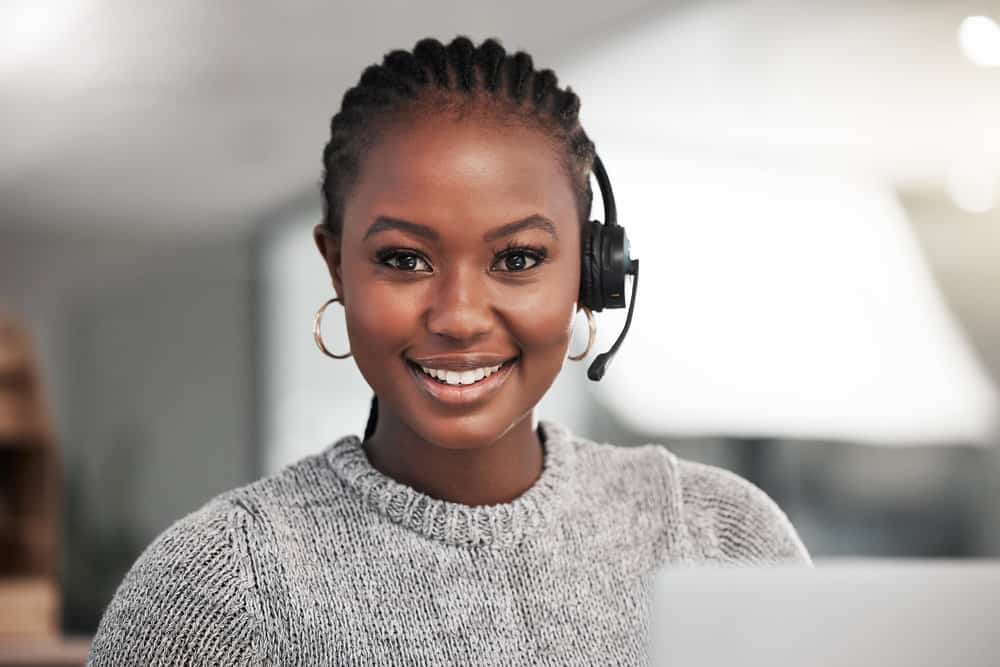 Her high ponytail, adorned with beautiful braid cuffs, adds a touch of elegance to her overall look with thick and thin braids.