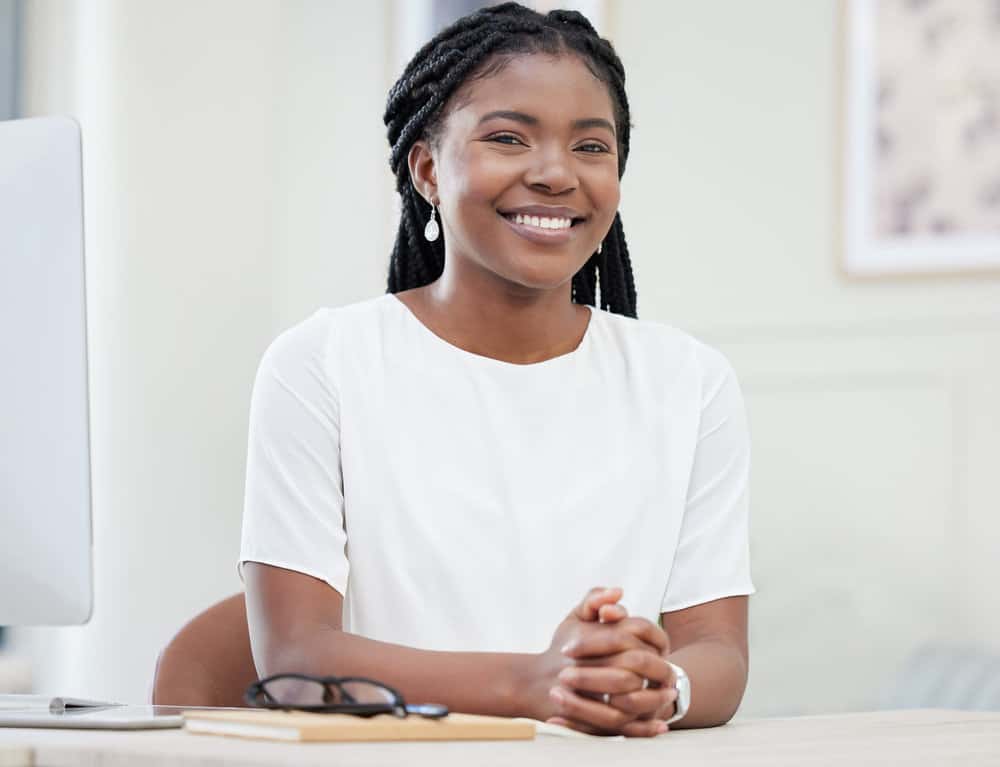 Her large knotless braids showcase her beautiful hair type, providing a stylish and low-tension option for protective styling.