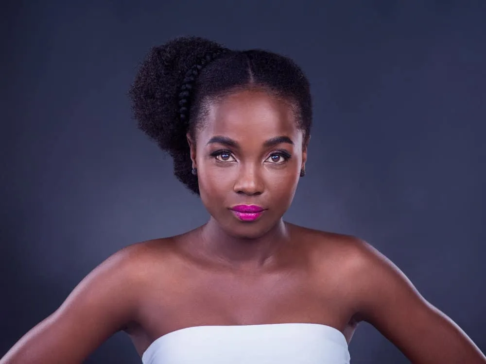 How to Seal Moisture in Hair: Moisturizing & Sealing Your Hair 1 A stunning black girl with fine hair maintains moisture with natural oils, like coconut oil and shea butter, for healthy hair growth.