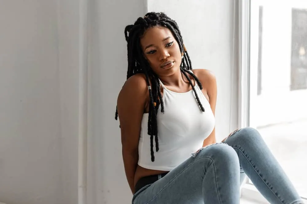 How to Take out Soft Locs: An Easy Way to Remove Soft Locs 1 A fashionable black female with crochet faux locs and styled baby hairs made with Kanekalon hair that looks like natural locs.