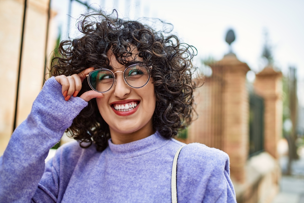 A female's hair texture is transformed with heat styling tools changing the primary component of hair, hydrogen bonds, creating beautiful curls from straight hair fibers.