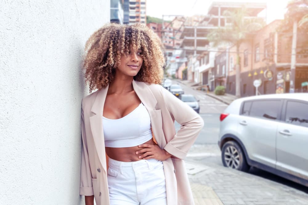 With her naturally curly or wavy hair, she embraces her texture and enhances her look with the right styling products and techniques when combing curly hair.