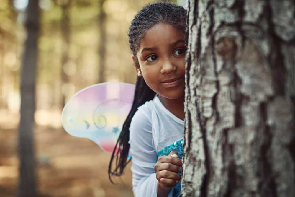 The adorable little girl proudly showcases her low-maintenance jumbo box braids, a protective style that adds length and volume to her fine hair.