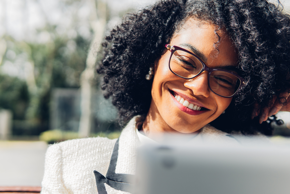 This black businesswoman knows the best hair tips for her hair type, using a shower cap to deep condition her hair and applying a curl-refreshing spray to revive her dry hair throughout the day.