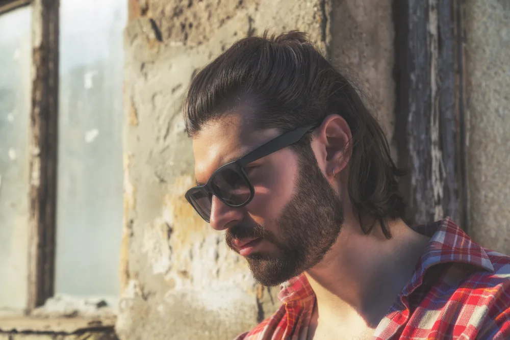 Mexican Mullet Hairstyles: Popular Mullet Haircuts & Styles 1 A guy with thick hair and an oval face shape wearing a short Mexican mullet haircut creates an edgy appearance for his straight hair.