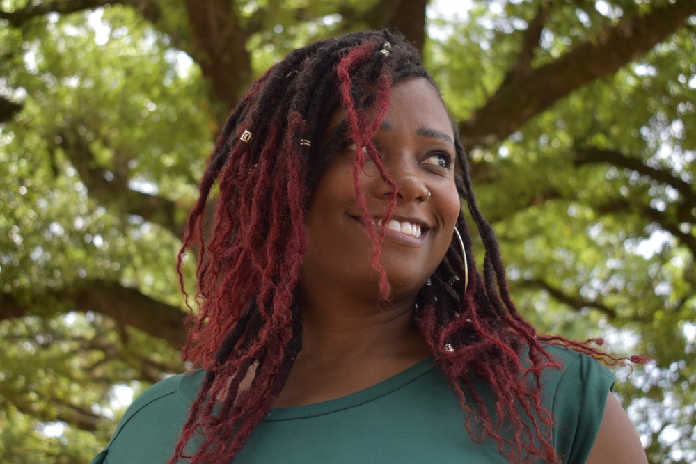 To refresh butterfly locs, she sprays them with water and seals the moisture, maintaining their gorgeous appearance instead of using shampoo to wash butterfly locs.