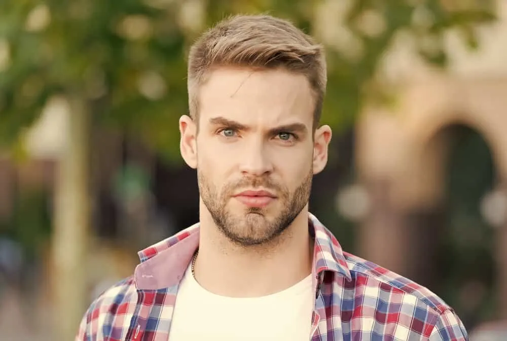Hairstyles for Men with Big Foreheads: Step-by-Step Tutorials 25 He completes his hairstyle with a spritz of hair spray, ensuring that his look stays intact throughout the day.
