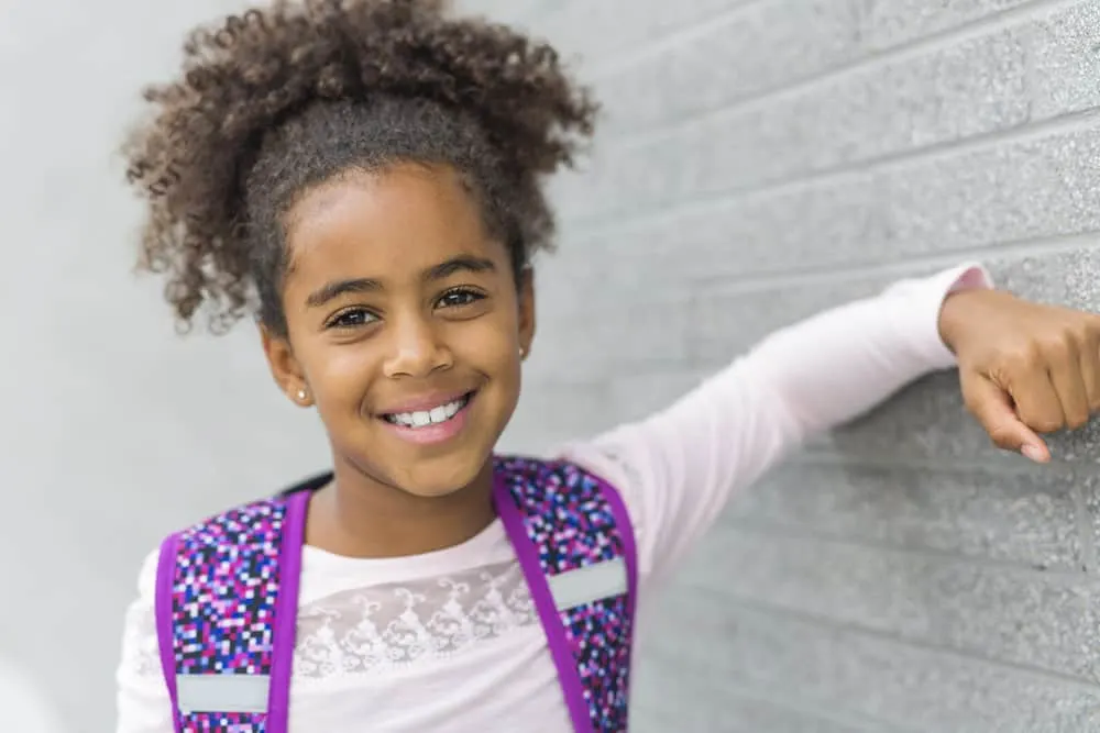 The little black girl's mom created one of our favorite cute hairstyles for her daughter using extensions, elevating her look with added length and volume.