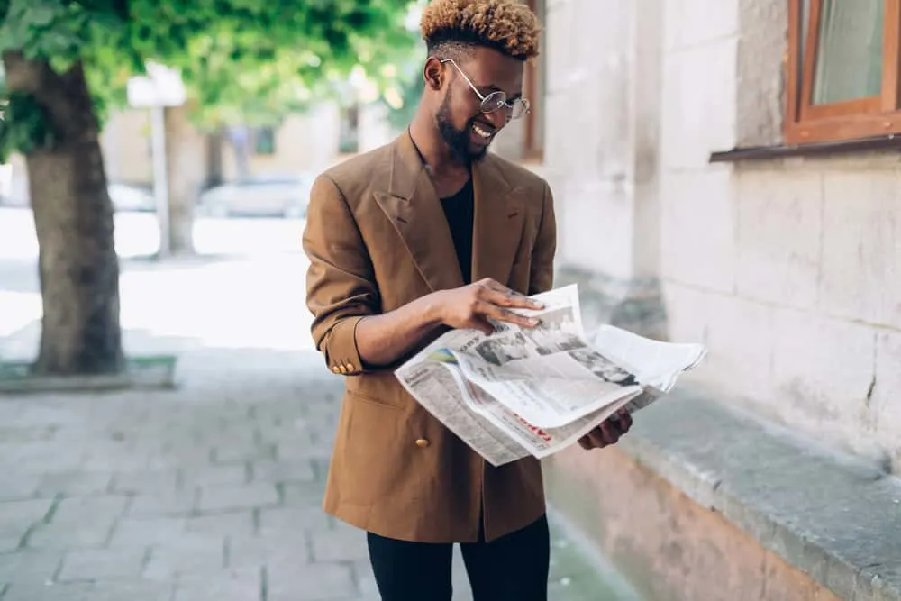 How to Do Frosted Tips: DIY Frosting Hair Tips Step-by-Step 5 A black man with an oval face shape maintains the vibrancy of his light blonde bleached hair with the help of purple shampoo, keeping any unwanted brassiness at bay.