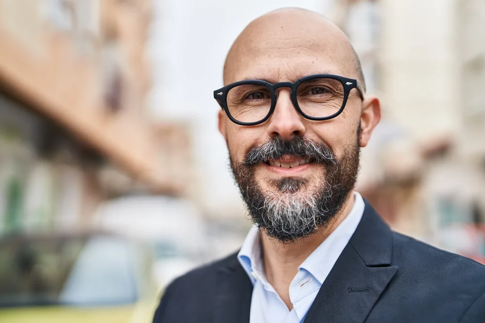 Bald on Top Hair on Sides: 14 Awesome Styles for Balding Men 15 The young man's typical bald appearance gives him a distinctive and confident appearance, highlighting his facial features and adding a sense of maturity.