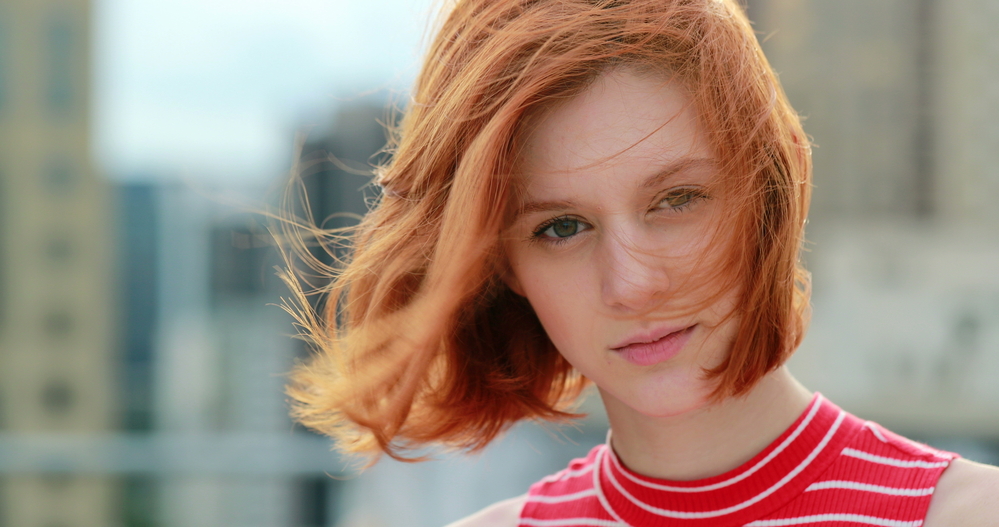 With a very short haircut, the young woman showcases one of our favorite hairstyles for teenage girls showing her individuality and fearless style with long bangs.