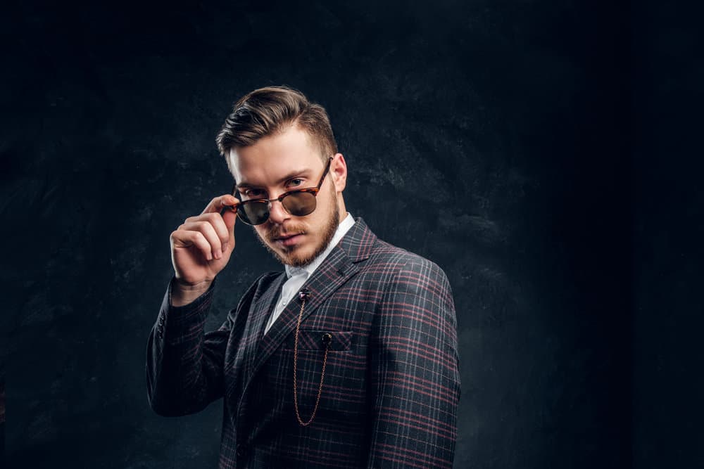 With the best Peaky Blinders haircuts and a carefully maintained lumberjack beard, the white man has his hair shaved to emanate the confidence and allure of a true Peaky Blinders character.