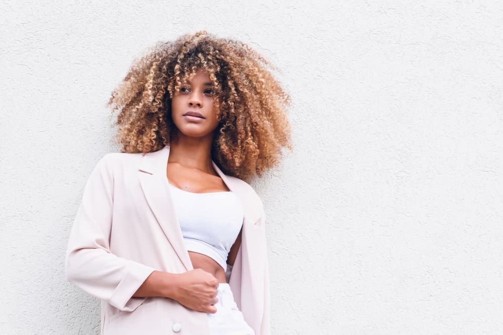 She understands the importance of learning how to brush curly hair correctly, using a soft hair brush or a detangling brush to maintain her healthy hair strands.