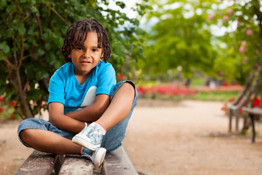 With a crown braid adorning his head, the young boy looks effortlessly stylish and charming, showcasing the versatility of these adorable braided hairstyles.