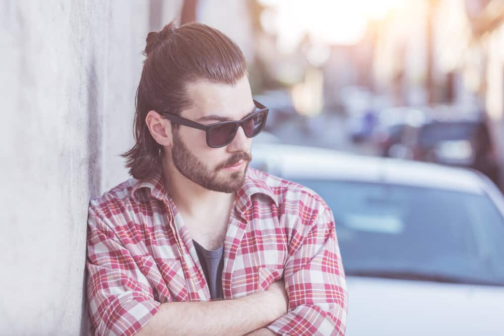 The edgy look of his Mexican mullet is achieved by carefully cutting the hair into different lengths, creating a dynamic and textured appearance.